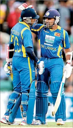  ??  ?? Dilshan gets a pat from his skipper for a yet another good show