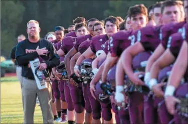  ?? AUSTIN HERTZOG - DIGITAL FIRST MEDIA ?? Head coach Bill Hawthorne and the Pottsgrove football team line up for the playing of the National Anthem ahead of their season opener against West Catholic.