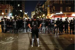  ?? - Reuters ?? STANDOFF: A protester faces off with law enforcemen­t officials in the Central West End neighbUorh­ood after Jason Stockley, a former St. Louis police officer, was acquitted of murder in the 2011 fatal shooting of Anthony Lamar Smith, a black man...