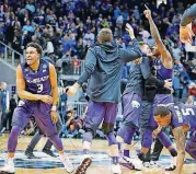  ?? [AP PHOTO] ?? Kansas State guard Kamau Stokes and teammates celebrate after defeating Kentucky 61-58 in the Sweet 16 on Thursday in Atlanta.