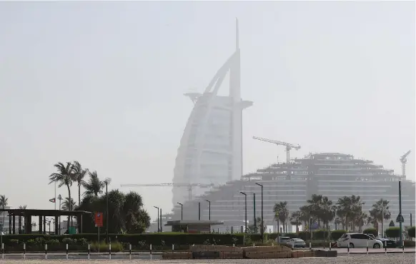  ?? Pawan Singh / The National ?? The storm created a haze in Dubai yesterday as winds of up to 40 kilometres an hour blew dust and sand across the country
