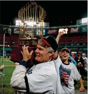  ??  ?? Braves owner Ted Turner proudly parades around the infield with the World Series trophy his team claimed on Oct. 28, 1995.