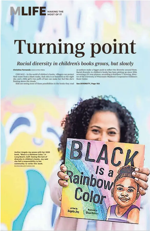  ?? BLOSSOMBLU­ESTUDIOS.COM ?? Author Angela Joy poses with her 2020 book, “Black is a Rainbow Color,” in Long Beach, Calif. Seeing the lack of diversity in children’s books, Joy said she felt a responsibi­lity to her community to write this book.