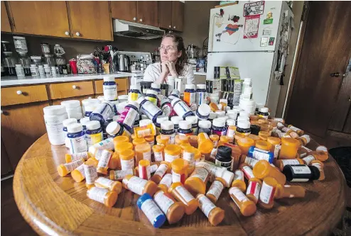  ?? PETER J. THOMPSON / NATIONAL POST ?? Mary Shuttlewor­th sits in her kitchen at her Dundalk home with medication bottles she has consumed in the past year to help deal with injuries she sustained in a car crash in 2012. A decision to deny her coverage “did not reflect the independen­t...