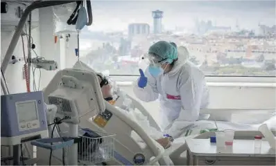  ?? Ferran Nadeu ?? Una sanitària atén un pacient amb Covid-19 a l’Hospital del Mar de Barcelona.