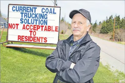  ?? SHARON MONTGOMERY-DUPE/CAPE BRETON POST ?? Claude Peach of Long Beach Road in Port Morien stands by a sign he posted on his front lawn protesting the Donkin Mine trucks hauling coal through the community. Peach said the roads are not wide and with summer coming parents are worried about their...