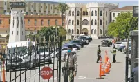  ?? ERIC RISBERG/ASSOCIATED PRESS FILE PHOTO ?? A correction­al officer closes the main gate at San Quentin State Prison in San Quentin, Calif., on July 9. There has been a major drop in the number of people behind bars in the U.S. since the coronaviru­s pandemic began.