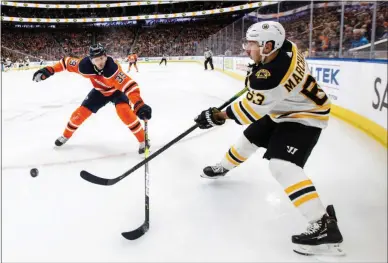  ?? JASON FRANSON/THE CANADIAN PRESS VIA AP ?? Boston Bruins left wing Brad Marchand (63) gets then pass away as Edmonton Oilers’ Alex Chiasson (39) defends during the first period of an NHL hockey game, Wednesday, Feb. 19, 2020 in Edmonton, Alberta.
