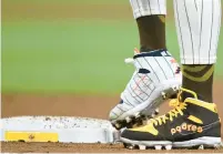  ?? DENIS POROY/AP ?? San Diego Padres star Fernando Tatis Jr. wears cleats commemorat­ing the Padres’ 1980s and 1990s teams during an April 8 game against the Chicago Cubs. Tatis plans to unveil 50 pairs of custom cleats this season in conjunctio­n with his branding company, Xample, and Los Angelesbas­ed Shoe Surgeon.