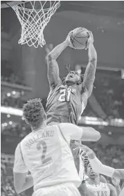  ?? Ed Zurga / Getty Images ?? Baylor’s Taurean Prince goes up for two of his 24 points against Texas’ Demarcus Holland in the second half of Thursday’s Big 12 tournament game.