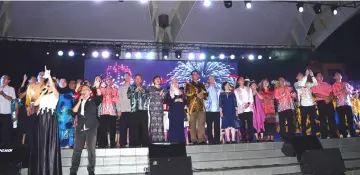  ??  ?? Abdul Karim (tenth right) and other dignitarie­s on stage as they watch the colourful display of fireworks.