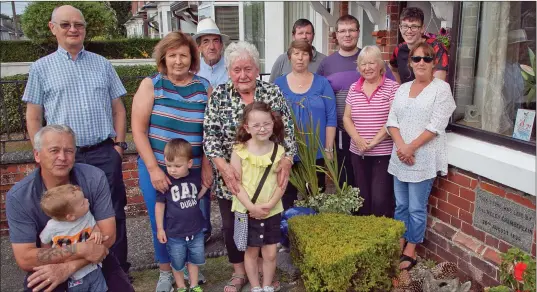  ??  ?? Residents of Beresford Terrace in Arklow gather by the stone marking when it was built to celebrate its 122nd anniversar­y.