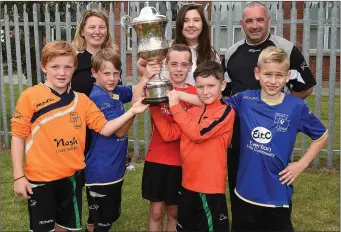  ??  ?? Square United players and committee members with the Rogers Memorial Cup.