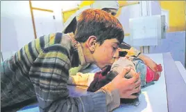  ?? AFP ?? A boy kisses a relative wounded in government shelling, at a hospital in Douma on April 4.