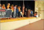  ?? LISA MITCHELL — DIGITAL FIRST MEDIA ?? Kutztown students placed a rose around the American flag for each Florida school shooting victim.