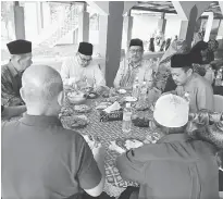  ??  ?? Ahmad Lai (facing camera, second left) and other guests enjoy the food specially prepared for the ‘Makan Tahun’ at Kampung Satap.