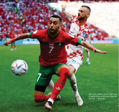  ?? — REUTERS ?? Morocco’s Hakim Ziyech (left) and Croatia’s Marcelo Brozovic tussle for the ball.