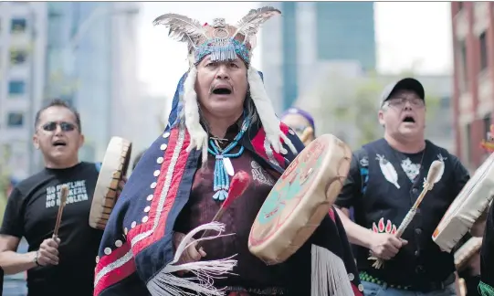  ?? CHRIS YOUNG/ THE CANADIAN PRESS FILES ?? Martin Louie, hereditary chief of the Nadleh Whut’en First Nation in British Columbia, protests pipelines at a march in 2012. He was seen as the “poster boy” for Indigenous opposition to Enbridge Inc.’s Northern Gateway pipeline. But lost in the heated protests was his desire to get a better deal for his impoverish­ed community.