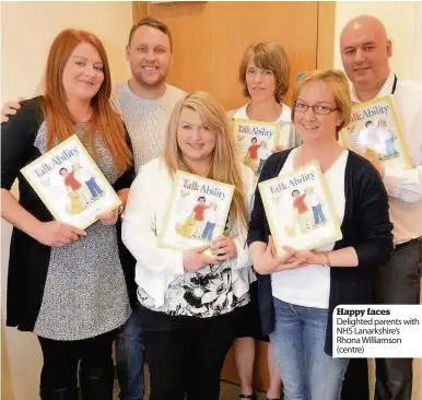  ??  ?? Happy faces Delighted parents with NHS Lanarkshir­e’s Rhona Williamson (centre)