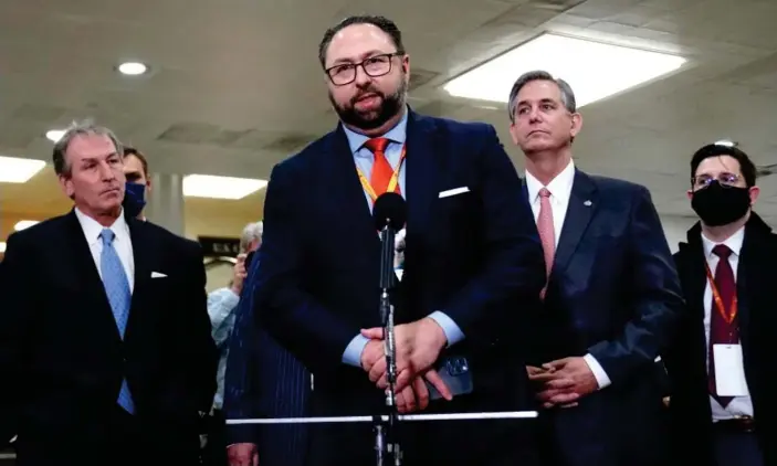  ?? Photograph: Erin Scott/Reuters ?? Jason Miller, middle, at Trump’s second impeachmen­t trial in February.