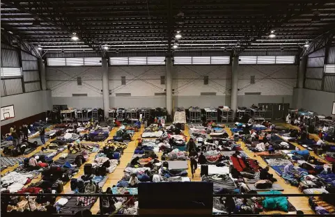  ?? Gregory Bull / Associated Press ?? Ukrainian refugees wait in a gymnasium in Tijuana, Mexico, on April 5. Hundreds of Ukrainian refugees arrived daily to this Mexican border city, where they waited two to four days for U.S officials to admit them on humanitari­an parole.