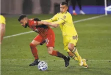  ?? Jessica Hill / Associated Press ?? Randall Leal ( right) pressures Toronto FC’s Auro Jr. in expansion Nashville’s surprise playoff win.