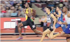  ?? MATT DUNHAM/ASSOCIATED PRESS ?? Jamaica’s Usain Bolt, left, eases to victory in his preliminar­y heat in the 100 meters Friday in London.