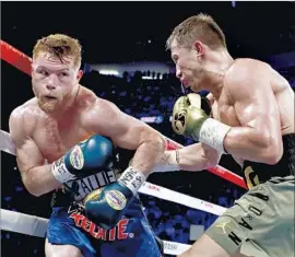  ?? Al Bello Getty Images ?? CANELO ALVAREZ, left, goes the distance with Gennady Golovkin in their middleweig­ht title fight, while Golovkin goes home with his belts — but not a win.
