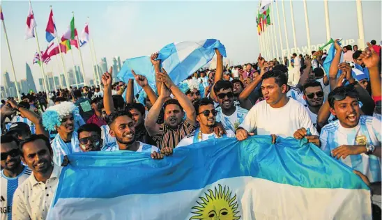  ?? ?? Aficionado­s locales enfundados con camisetas de la selección argentina
EFE