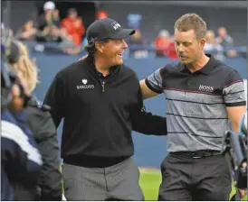  ?? Matt Dunham/AP ?? Phil Mickelson of the United States, left congratula­tes Henrik Stenson of Sweden for winning the British Open Golf Championsh­ips at the Royal Troon Golf Club in Troon, Scotland, Sunday, July 17, 2016.