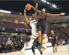  ?? David J. Phillip / Associated Press ?? UConn’s Christyn Williams is fouled by Houston’s Julia Blackshell- Fair ( 23) during the first half on Saturday in Houston.