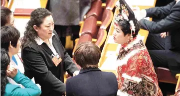  ?? — AFP photo ?? Delegates talk during the fifth plenary session of the first session of the 13th National People’s Congress (NPC) at the Great Hall of the People in Beijing.