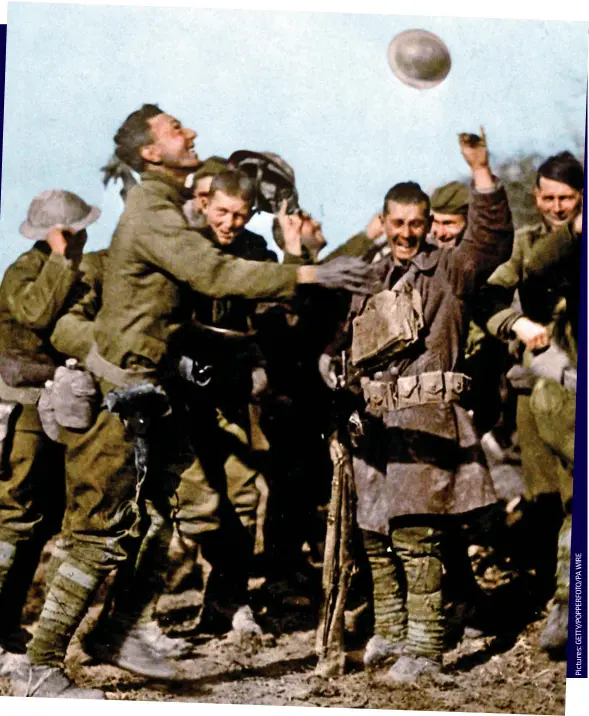  ??  ?? Glad it’s all over: In the mud of Northern France, Allied soldiers — like these Americans — congratula­ted each other on surviving