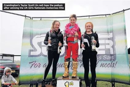  ??  ?? Cramlingto­n’s Taylor Scott (in red) tops the podium after winning the UK Girls Nationals motocross title