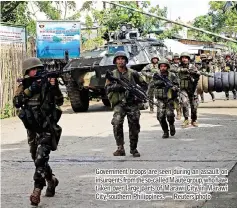  ??  ?? Government troops are seen during an assault on insurgents from the so-called Maute group,who have taken over large parts of Marawi City, in Marawi City, southern Philippine­s. — Reuters photo