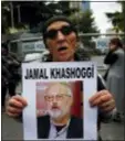  ?? LEFTERIS PITARAKIS - THE ASSOCIATED PRESS ?? An activist, member of the Human Rights Associatio­n Istanbul branch, holds a poster with a photo of missing Saudi journalist Jamal Khashoggi, during a protest in his support near the Saudi Arabia consulate in Istanbul, Tuesday.