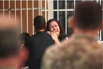  ?? FELIX MARQUEZ AP ?? The mother of a Mexican soldier who was killed by drug cartel gunmen cries at her son’s wake in Veracruz, Mexico, on Oct. 19. The soldier died during an attempt to arrest Ovidio Guzman, son of convicted drug lord Joaquin “El Chapo” Guzman.