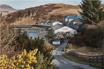  ??  ?? Bunnahabha­in Distillery in Islay. When the distillery opened in 1881, the owners constructe­d a path to the main road for horse-drawn carriages to bring coal and barley to the facility. Today, 40-foot trucks take whisky away to be bottled.