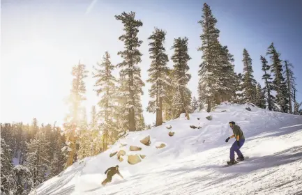  ?? by Max Whittaker / Special to The Chronicle ?? Above: Snowboarde­rs enjoy opening day at Heavenly Ski Resort in South Lake Tahoe. Below: Zachary Kordal sprays disinfecta­nt on rental ski boots, one of numerous measures resorts are taking to guard against the coronaviru­s.