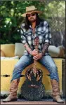  ?? (The Associated Press/Chris Pizzello) ?? Singer-songwriter Billy Ray Cyrus poses for a portrait with an Ovation guitar presented to him by Neil Diamond in 1992, at his home in Los Angeles on Jan. 30. The Kentucky-born singer won his first Grammy this year for his collaborat­ion with rapper Lil Nas X on “Old Town Road.” His new three-song EP,
The Singin’ Hills Sessions Vol. 1 Sunset, was released Jan. 31.