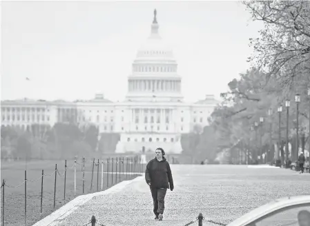  ?? JACK GRUBER/ USA TODAY ?? Walking paths on the National Mall in Washington, D. C., are nearly deserted on Monday.