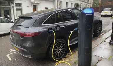  ?? (AP/Courtney Bonnell) ?? An electric vehicle charges at a public fast-charging station in London earlier this month.