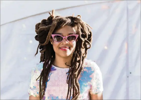  ?? ERIKA RICH PHOTOS FOR AMERICAN-STATESMAN ?? Valerie June, a singer-songwriter from Memphis, Tenn., shows off her light-reflecting outfit backstage Oct. 13 at the Austin City Limits Music Festival in Zilker Park. June says the world needs more light these days.