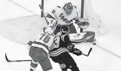  ?? AP ?? Hurricanes goalie Antti Raanta, top, blocks a shot by the Bruins’ Brad Marchand as the Hurricanes’ Brady Skjei (76) defends on Thursday in Boston.
