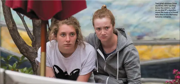  ??  ?? Two grief-stricken Irish students, who say they knew the victims, look on as sheriff’s deputies move the body of a friend who died in the Berkeley balcony collapse.