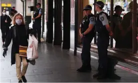  ?? Photograph: Dean Lewins/EPA ?? NSW police stand guard outside a hotel in Sydney on Thursday that has been declared a ‘human health response zone’. State and federal government­s have declared emergencie­s in the wake of the coronaviru­s pandemic.