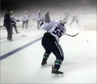  ?? THE ASSOCIATED PRESS ?? Vancouver Canucks players practice at the foggy Mercedes-Benz Arena in Shanghai, China, on Tuesday.