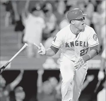  ?? Stephen Dunn Getty I mages ?? MIKE TROUT tosses his bat after his walk- off home run for the Angels against Boston closer Koji Uehara.