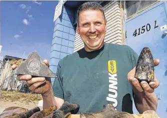  ?? BRENDAN MILLER/POSTMEDIA ?? Mike Darbyshire, Owner of Just Junk, found thousands of fossilized bones and imprints and pieces petrified wood. The discovery was made in several boxes and bags in the basement and shed of home while cleaning-up.