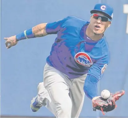  ??  ?? After playing center field Thursday ( above), Javy Baez played first base Friday, though he didn’t have his own first baseman’s mitt. MICHAEL SNEED Trump says Rickettses should worry about Cubs, not him. Page 2